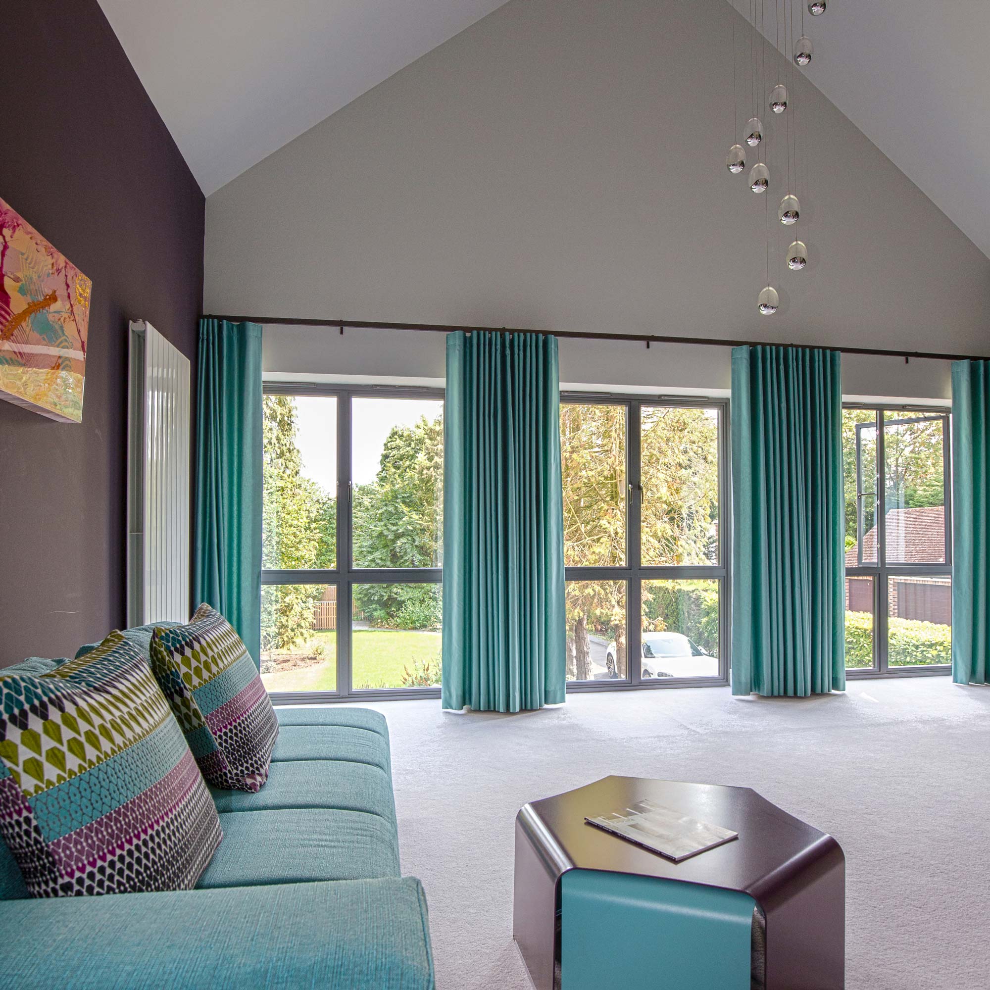Vaulted large bedroom purple and teal colours